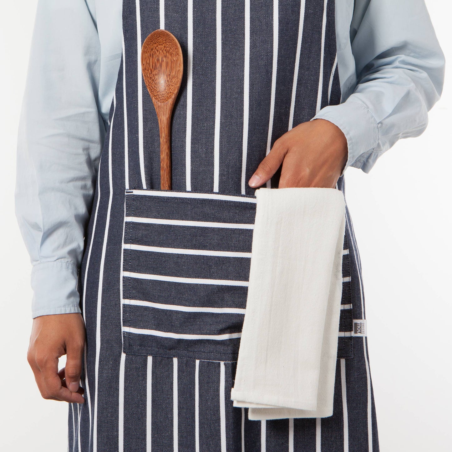 Person wearing a striped apron with a wooden spoon and white towel in the pocket on a white background