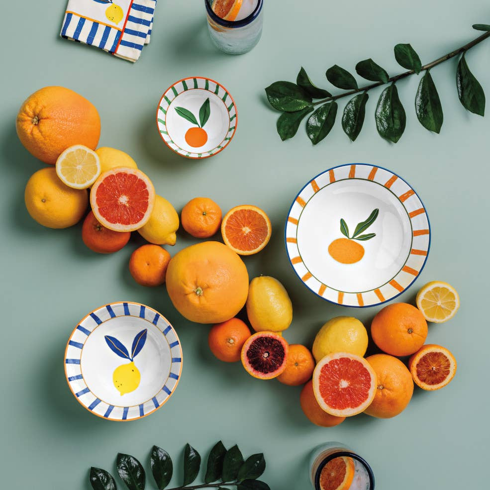 Ceramic plates with fruit designs on a green background