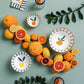 Ceramic plates with fruit designs on a green background