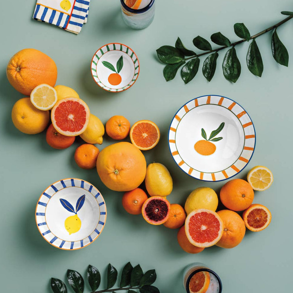 Ceramic plates with fruit designs on a green background