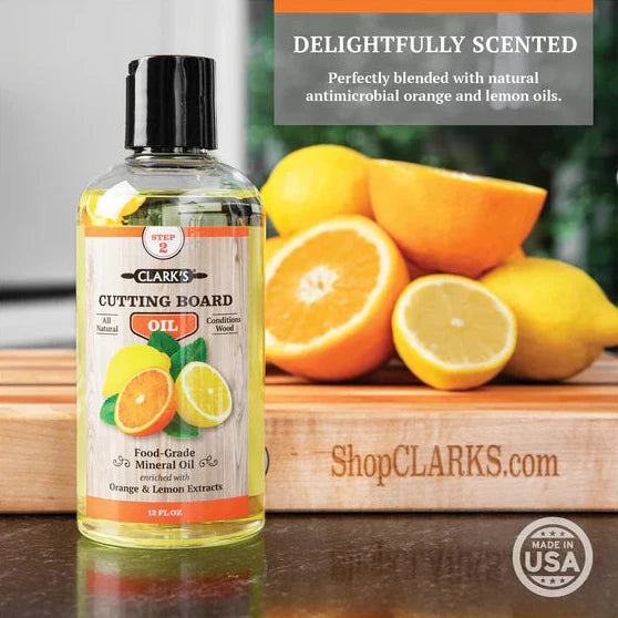 clark's cutting board oil being used on a cutting board on a counter delightfully scented perfectly blended with natural anti microbial orange and lemon oils