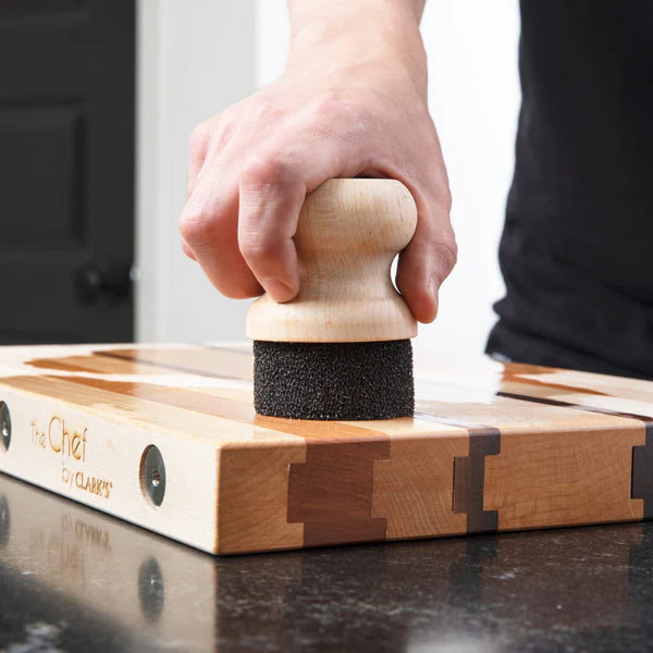 Clark's round wax and oil applicator being used on wood cutting board