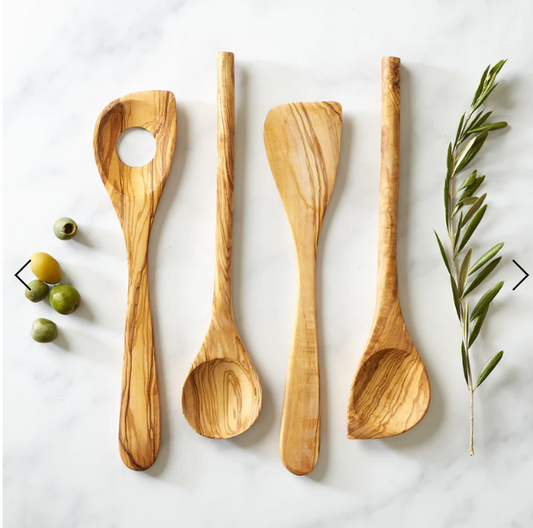 olive wood spoon with pointed end on a counter with other olive wood cooking tools