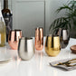 Savor Sauvignon Blanc and Chardonnay from an eye-catching pair of stemless copper tumblers. Each polished and perfectly rounded to fit the curve of your palm, these mirror-finished metal glasses collect and intensify the aromas of your drink for an appetizing taste every time. A fun way to show off your wine-tasting skills! Throw in a few wine facts and you've got yourself the makings of a successful wine night.