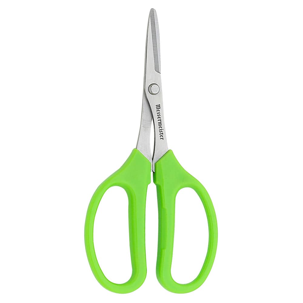 kitchen sissors with green handles on white surface. 