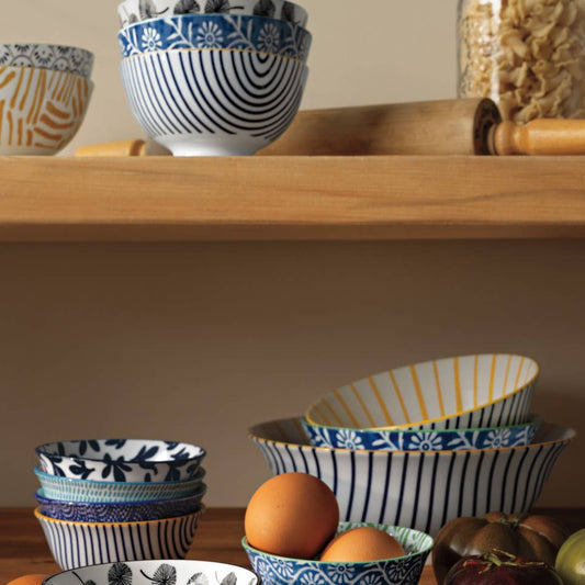 Set of decorative bowls with different patterns on a wooden surface.