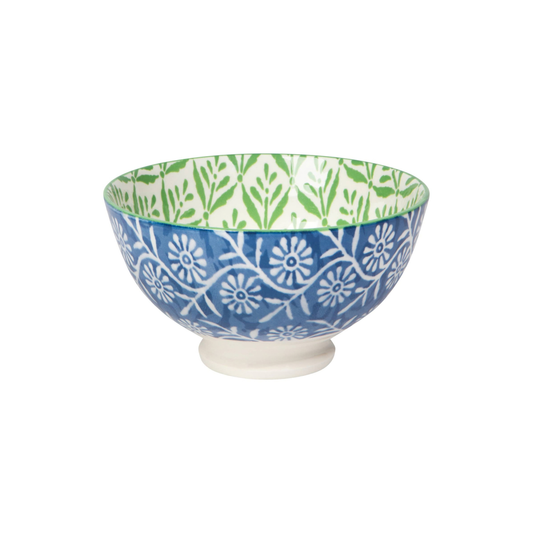 Decorative ceramic bowl with blue and white floral pattern on a white background