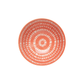 Coral-colored plate with a circular pattern on a white background