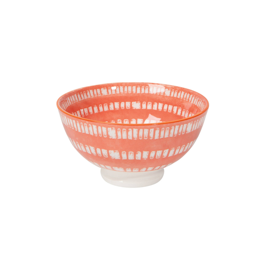 Coral-colored bowl with white pattern on a white background