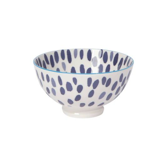 White bowl with blue spotted pattern on a white background