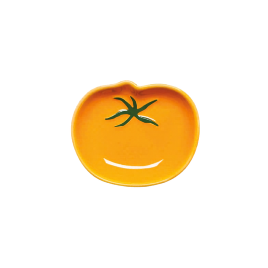 Yellow ceramic dish shaped like a tomato on a white background