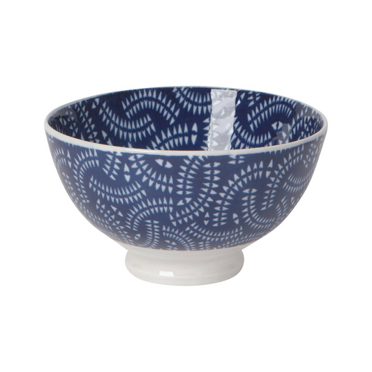 White bowl with blue stamped pattern on a white background