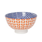 white bowl with orange stamped pattern outside and blue stamped pattern on the inside on white background