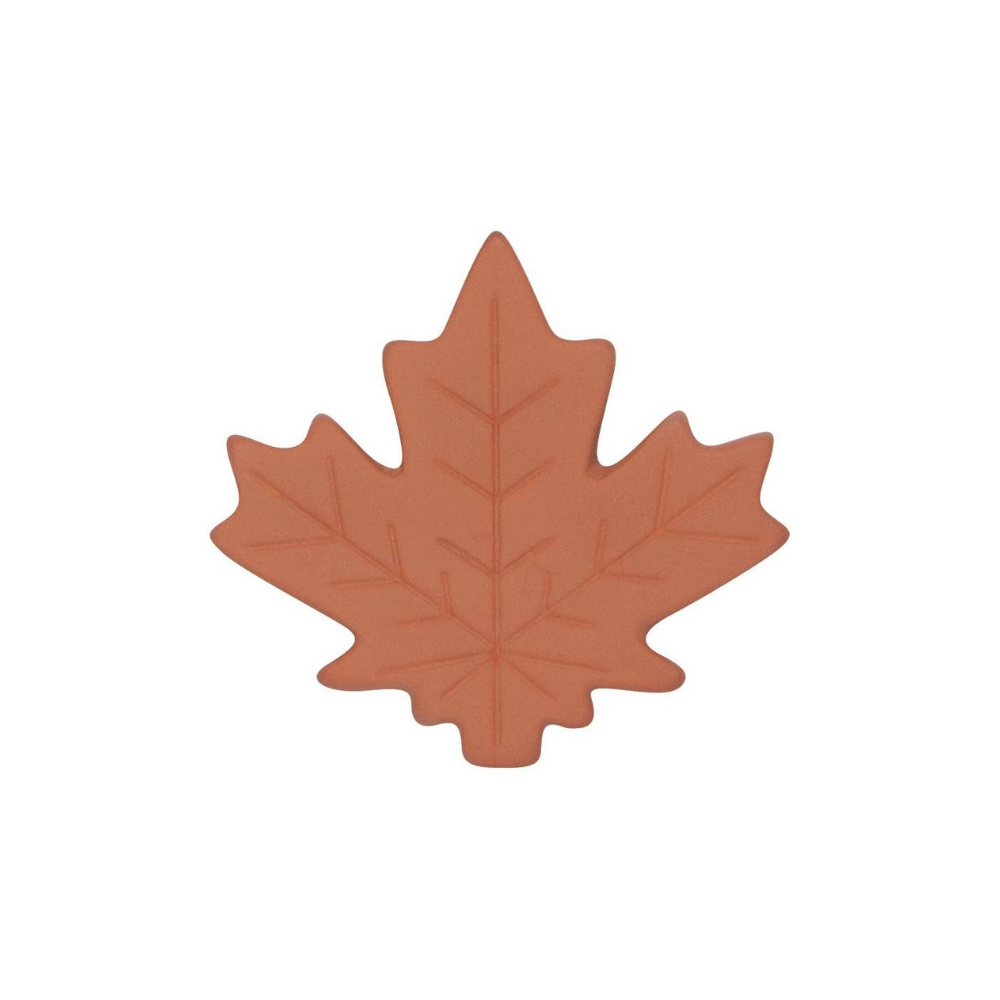 A terracotta-colored maple leaf-shaped item, likely a silicone baking mat or cookie cutter, shown on a solid white background.