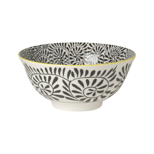 White bowl with black stamped vine pattern on the inside and out with yellow edge on a white background