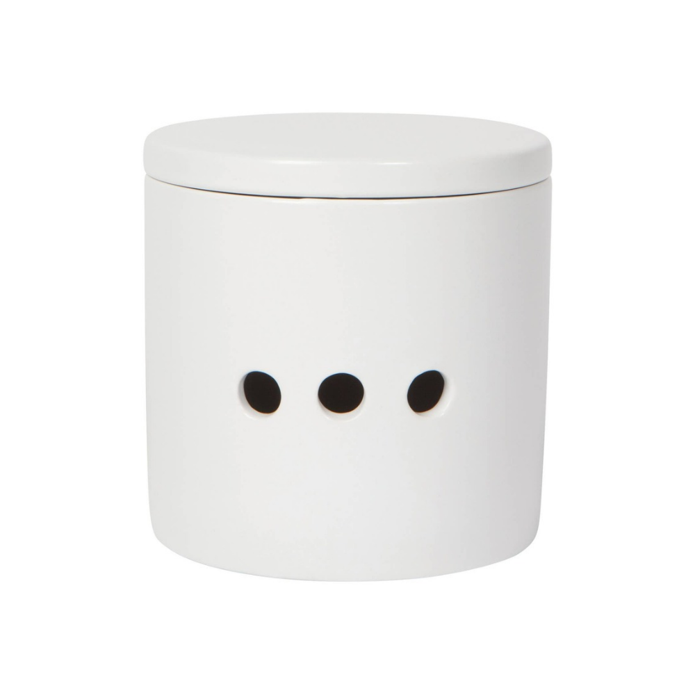 A minimalist white cylindrical container with a matching lid and three small black circular cutouts on the front, set against a solid white background.