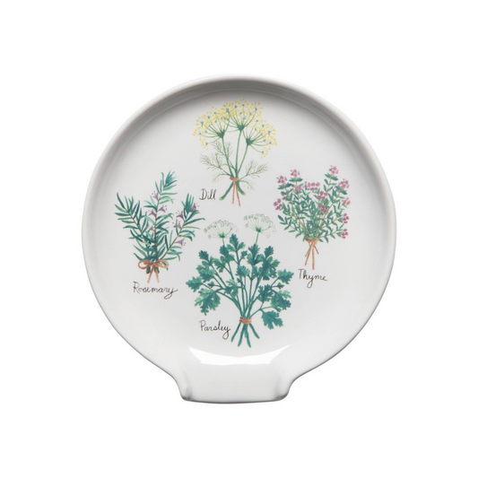 A white ceramic spoon rest featuring a botanical illustration of four herbs: Dill, Rosemary, Parsley, and Thyme, with their names written in cursive script.