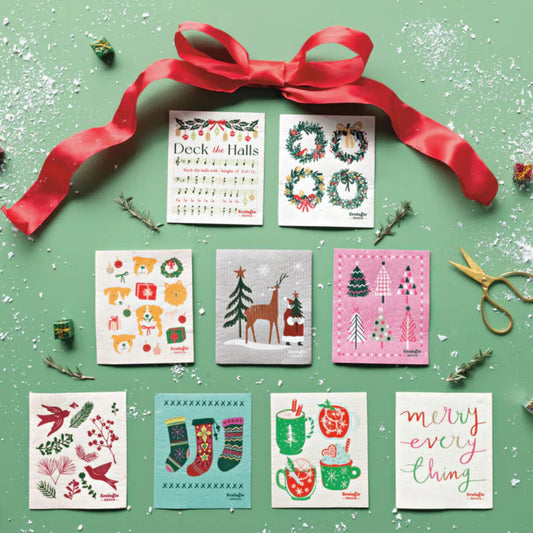 Collection of Christmas-themed dishcloths with a red ribbon on a green background