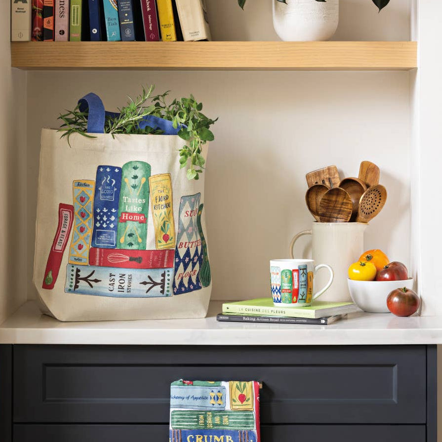 Bookshelf with books, a tote bag, and decorative items.
