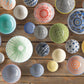 Collection of colorful ceramic bowls on a wooden surface