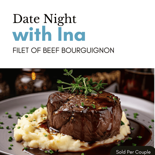 Filet of beef bourguignon on a plate with mashed potatoes, garnished with herbs, on a blurred background.