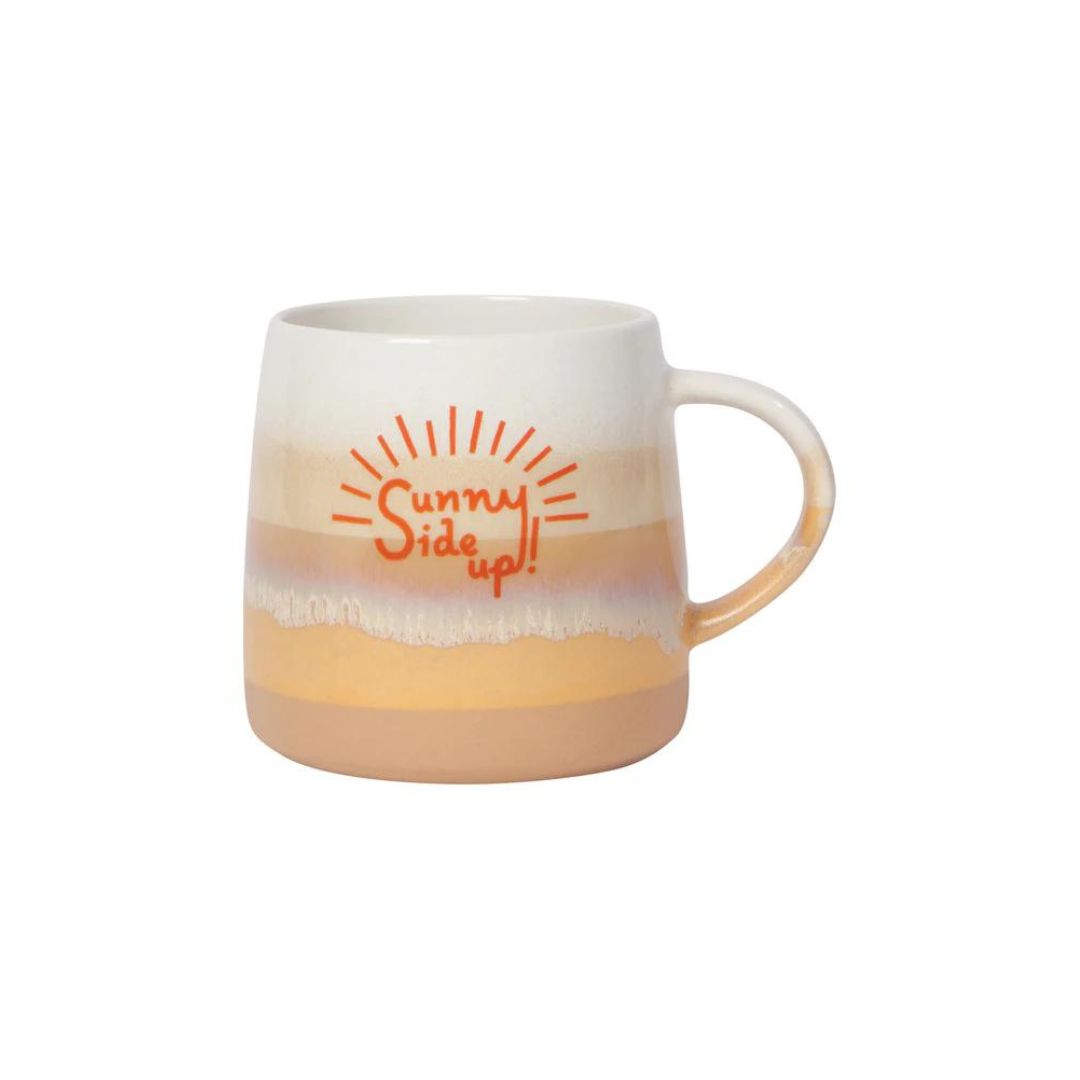 the Sunny Side Up Mug from Danica Jubilee! This cheerful 12oz glazed stoneware mug features sandy ombre stripes and the cheerful phrase “Sunny Side Up!” in vibrant orange.