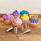 Cupcakes with colorful frosting and piping tips on a wooden surface
