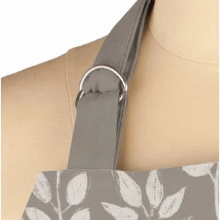 The MUkitchen&nbsp;Designer Apron in a white on gray botanical print, where style meets functionality in the kitchen. With the same classic tailoring as our beloved Classic Chef Apron, this apron showcases an on-trend design that will make a statement. 