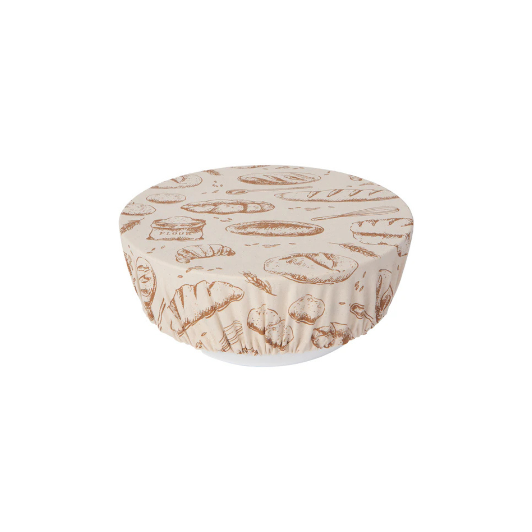 A beige cotton bowl cover with a bread loaf pattern, designed to fit over a bowl to allow dough to rise.