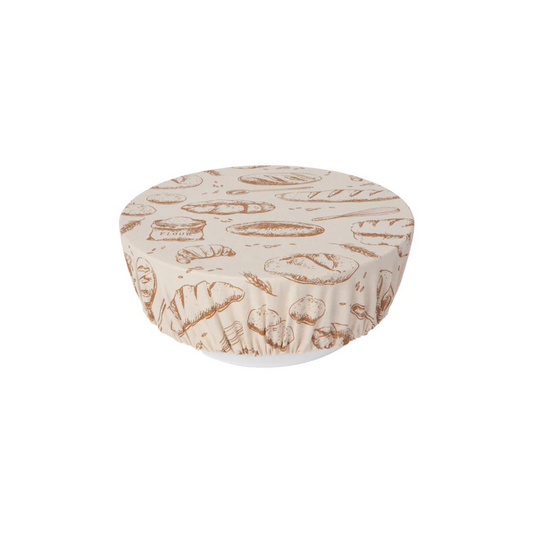 A beige cotton bowl cover with a bread loaf pattern, designed to fit over a bowl to allow dough to rise.