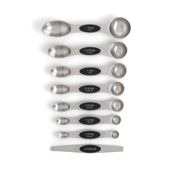Set of stainless steel measuring spoons with black labels on a white background
