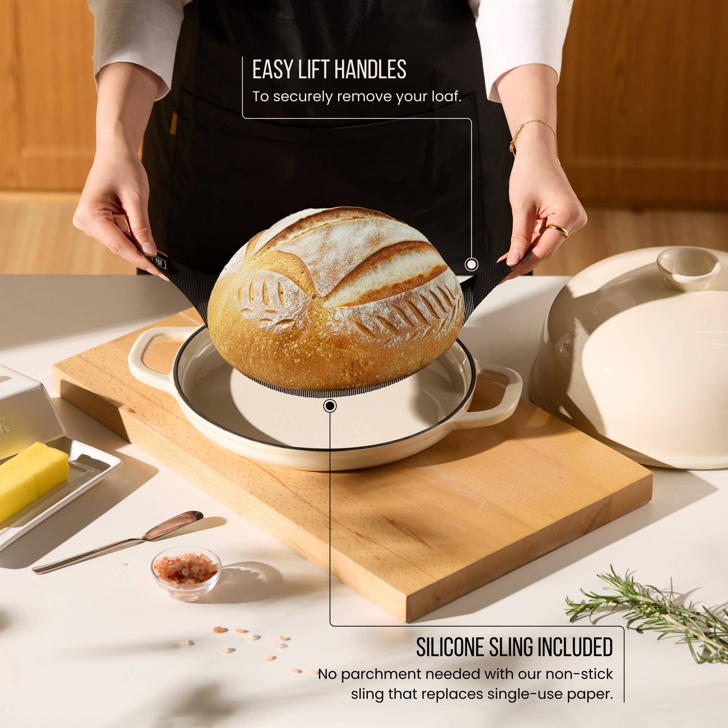 Person lifting a loaf of bread from a baking dish with text about easy lift handles and silicone sling.
