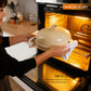 Person placing a ceramic dish with a lid into an oven, with text about the dish's features.