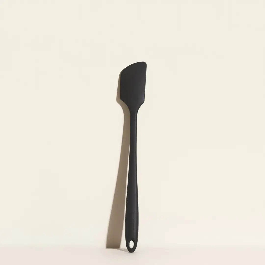 Black spatula on a beige background