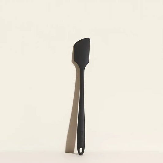 Black spatula on a beige background