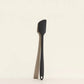 Black spatula on a beige background