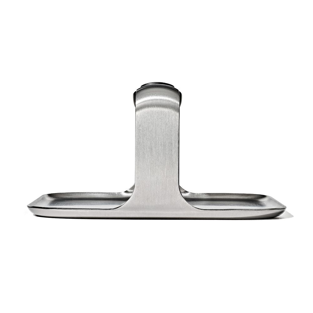 Front profile view of a metal griddle press. 