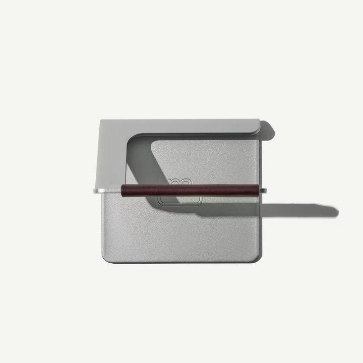 Metallic rectangular object with a handle on a white background