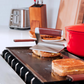 Grilled sandwiches on a hotplate with kitchen items in the background
