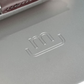 Close-up of a gray surface with a logo embossed on it, likely from a brand.