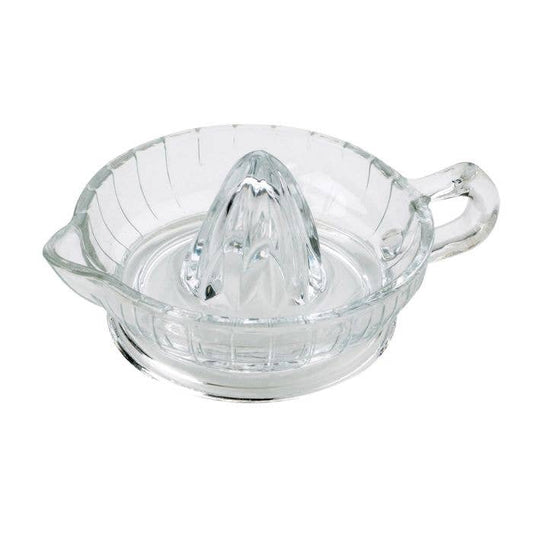Clear glass manual juicer on a white background