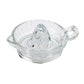 Clear glass manual juicer on a white background
