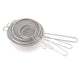 Set of metal mesh sieves on a white background