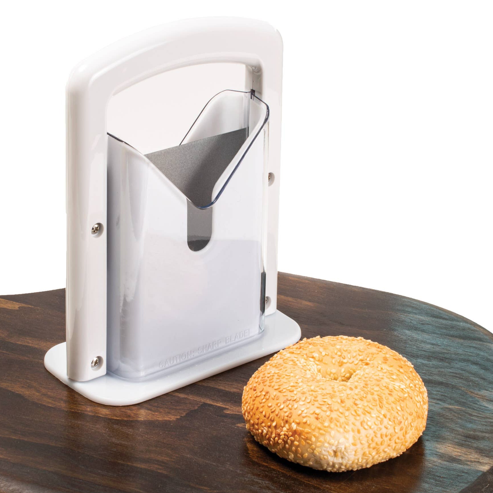 Bagel slicer on a wooden surface with a bagel next to it