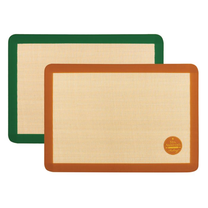 A green and a brown silicone baking mat on a white background