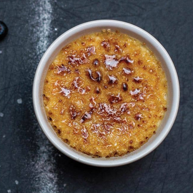 Creme bréleé in a white bowl on a dark surface