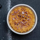 Creme bréleé in a white bowl on a dark surface