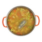 Pasta soup in a pot with orange handles on a white background