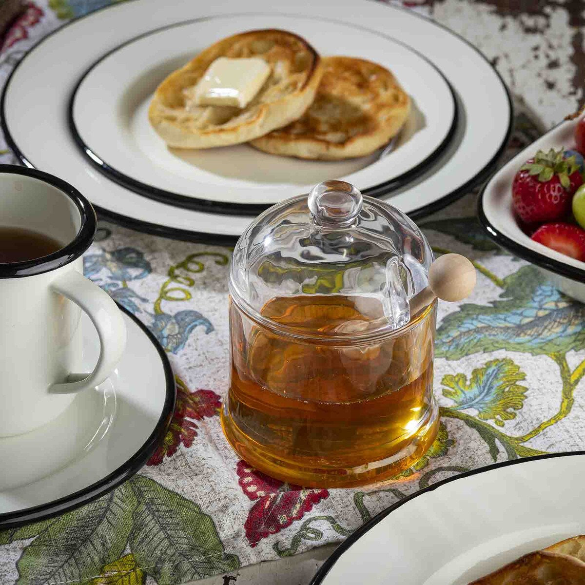 Perfect for drizzling honey onto your tea, toast, or porridge, this elegant glass jar holds up to 8¼ oz of honey, ready to go whenever you need it. Just dip, twirl the wooden handle between your fingers, and transport that golden goodness without any messy drips. The light wood dipper gives a traditional vibe, and if you love it, you can even grab the dipper on its own!