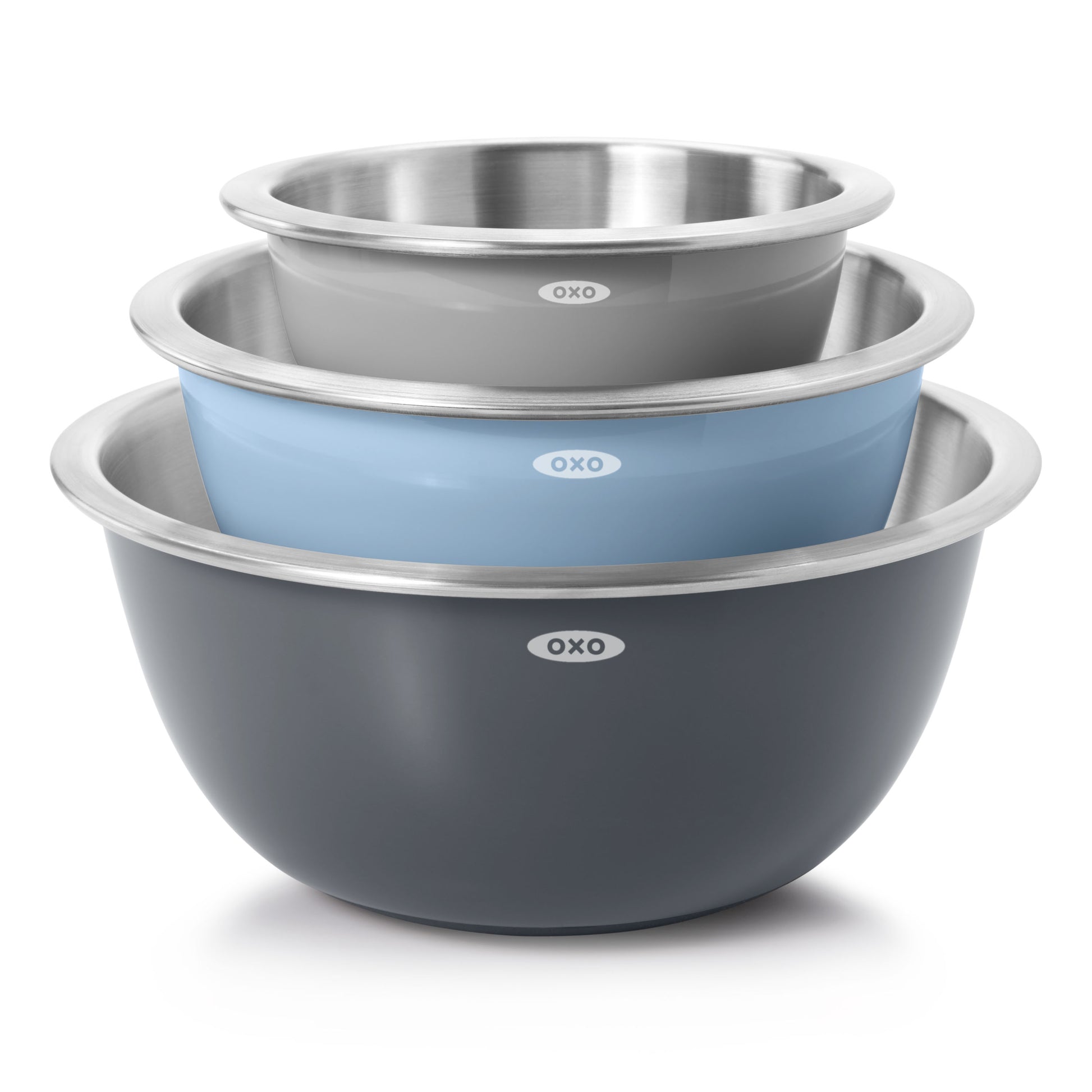 Set of three OXO stainless steel mixing bowls in gray, blue, and black on a white background